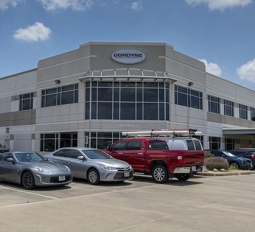 Cordyne facility exterior with company vehicles in parking lot
