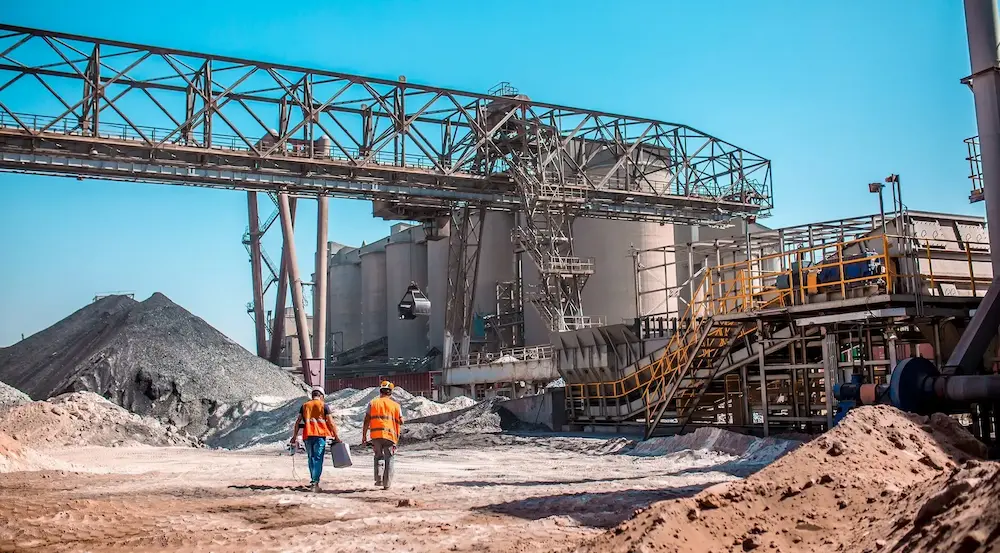Workers at an industrial mining and aggregate processing facility
