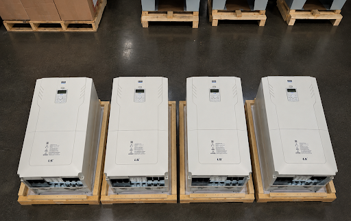 Four LS Electric variable frequency drives with control panels facing up
